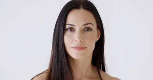 Woman Smiling in Front of a White Background