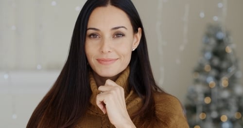 Smiling Woman Posing Near Christmas Tree Lights