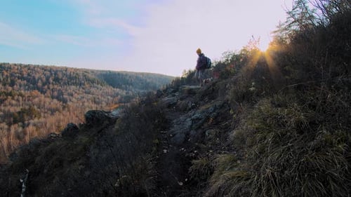 Woman and Dog Walk on Slope