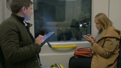 Couple on Train Using Mobile Devices