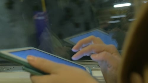 Tablet In Hands Of Subway Passenger