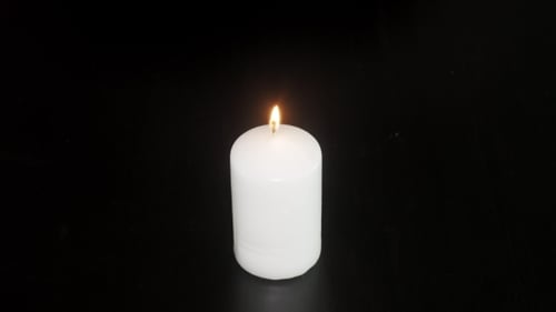 White Candle Flame Extinguishes and Releases Smoke