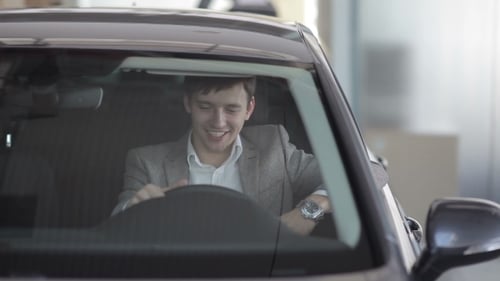 Excited Man Shows Keys Inside a Car
