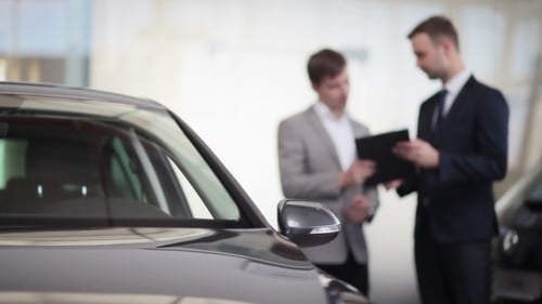 Sales Manager Assisting Client In a Car Dealership