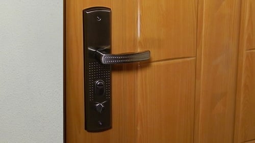 Hand Pressing Down a Door Handle