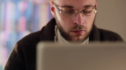 Man With Glasses Focused On Laptop