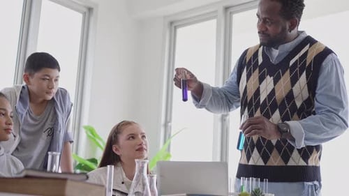 Instructor Demonstrating Science Experiment to Students