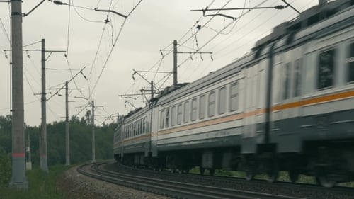 Suburban Train Moving Along The Railroad