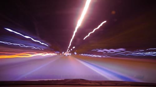 Blured Vehicles Moving Fast at Night in City