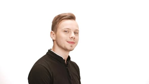 Smiling Young Man Points and Winks at the Camera