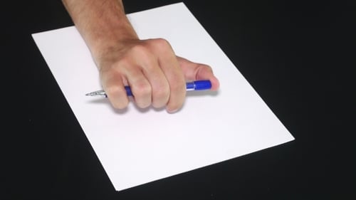 Hand Prepares to Write With Pen on Paper