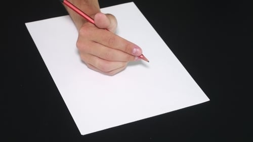 Hand Spinning Red Pencil Over Blank White Paper