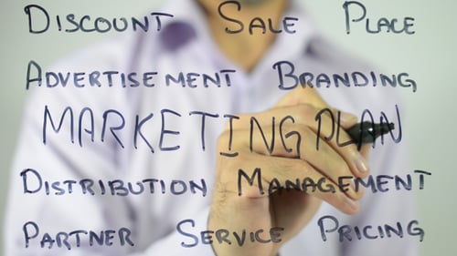 Writing Marketing Plan on Clear Surface Close Up