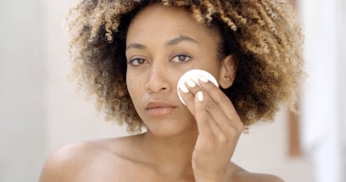 Young Woman Cleaning Skin