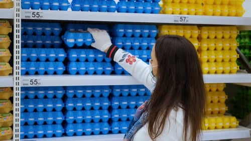 Woman in Protective Mask Buying Eggs in Grocery