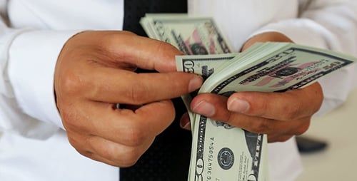 Man Counting Fifty Dollar Bills