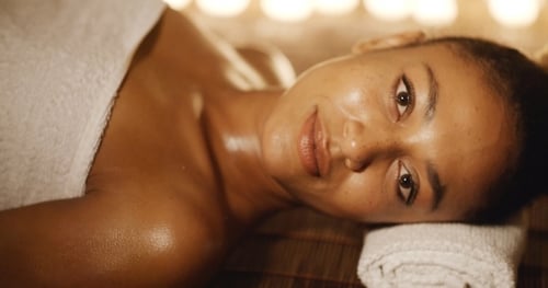 Woman Lying Down Relaxing Wrapped in Towel