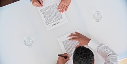 Businessmen Sign Contract, Shake Hands at White Table