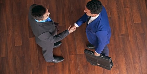 Men in Suits Shaking Hands Overhead View