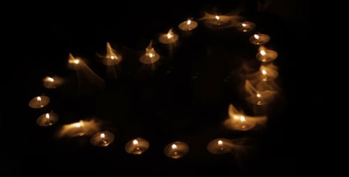 Candles Burning to Create Heart Shape in Dark