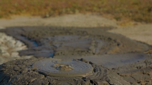 Gray Mud Slowly Erupting Out Of Active Volcano