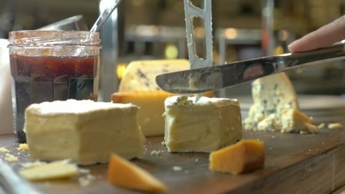 Cutting Cheese Selection With Knife On Grazing Board