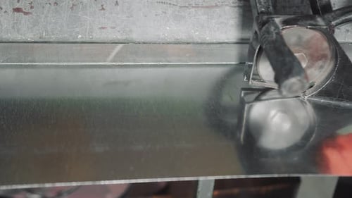 A Professional Engineer Works with a Metal Sheet. The Master Makes Incisions on a Metal Sheet To