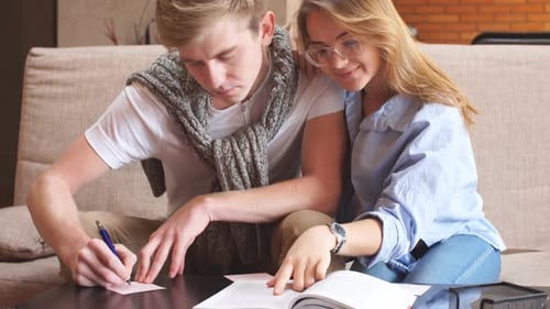 Young Couple Studying and Working Together Indoors