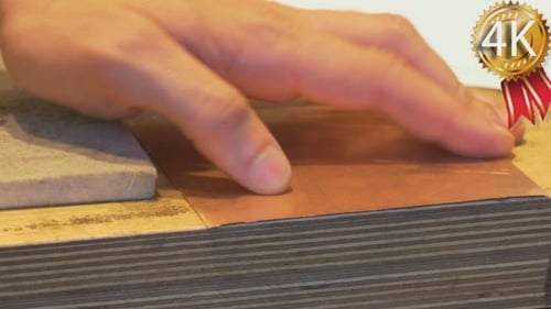 Man's Hands Take The Square Piece of Copper Plate