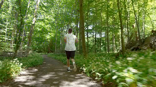 Young Man Running On Trail