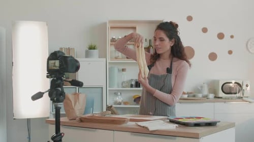 Woman Kneading Dough in a Bright Kitchen