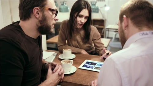 Business Meeting In Cafe. Team Is Using The Tablet