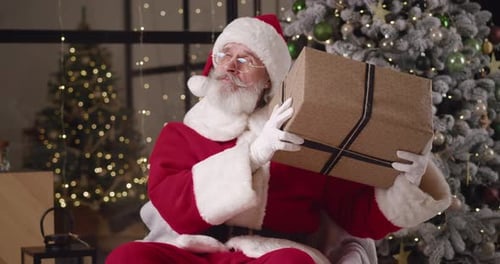 Santa Claus Holding Christmas Present in Festive Setting