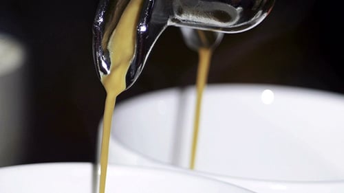 Close-up of Rich Espresso Pouring into Cups