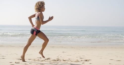 Woman Running On The Beach