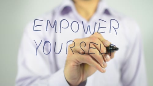 Empower Yourself Written on Glass by Person