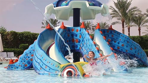 Little Girl Riding On a Water Slide