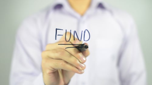 Man Writes Fund on Clear Surface