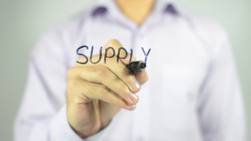 Hand Writes the Word 'Supply' on Clear Surface