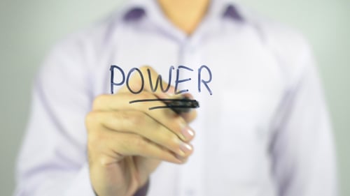 Hand Writes the Word Power with Marker