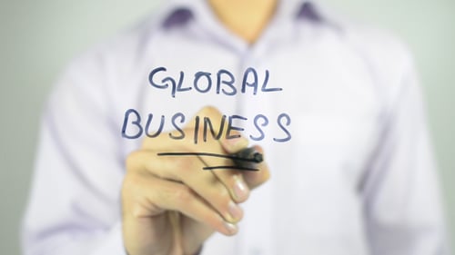 Global Business Written with Marker by Man