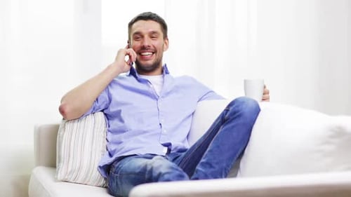 Smiling Man Chatting on Phone at Home