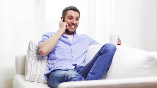 Young Adult Chatting on Phone at Home