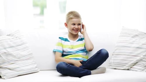 Smiling Child Talking on Smartphone at Home