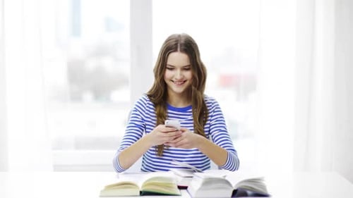 Female Student Using Smartphone at Desk