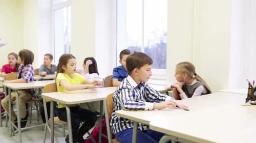 Group Of Students With Pens Sitting At School 1