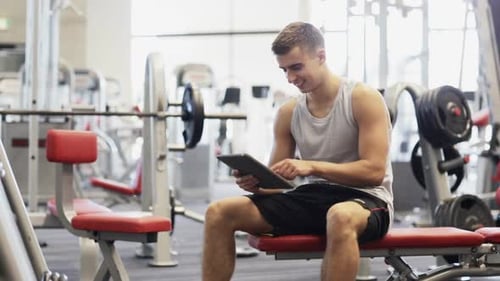 Smiling Young Man With Tablet Pc Computer In Gym 1
