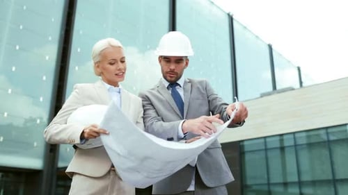 Architects Reviewing Blueprints at Construction Site