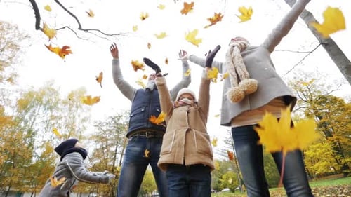 Happy Family Playing With Autumn Leaves In Park 1