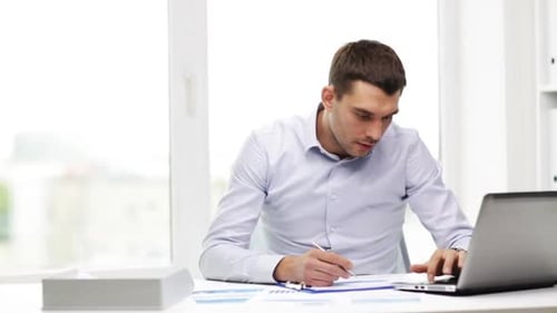 Busy Businessman With Laptop And Papers In Office 5